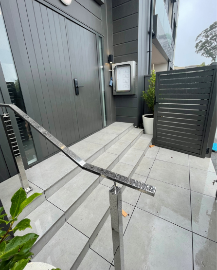Anchorjak floating tile Entrance for an Apartment block in Remuera. The Tiles are floating over compact metal on our aluminium frame. Stainless Steel Handrail also by Glass Vice
