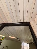 Vertical Weatherboard used on walls and soffits, complementing with panelling on interior.