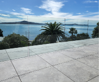 Floating Tile surface on Aluminium frame. Clearline Glass balustrade attached below the deck.