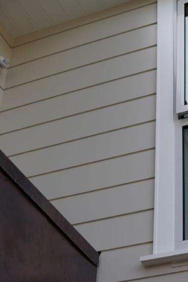 A dressed face finished bevelback weatherboard with a paint finish was specified for this reclad in Takapuna.