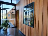 Random width and depth Western Red Cedar (SP5) coated with Colorwood and fire rated to achieve Group 1S rating. Complementing the exterior cedar cladding (SV5) and coating.