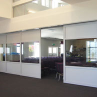 Bypass sliding door system with 2-5 doors sliding from one pocket