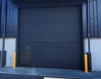 Powdercoated Steel Roller Shutter Door with additional security bollards.