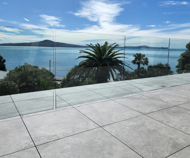 Floating Tile surface on Aluminium frame. Clearline Glass balustrade attached below the deck.